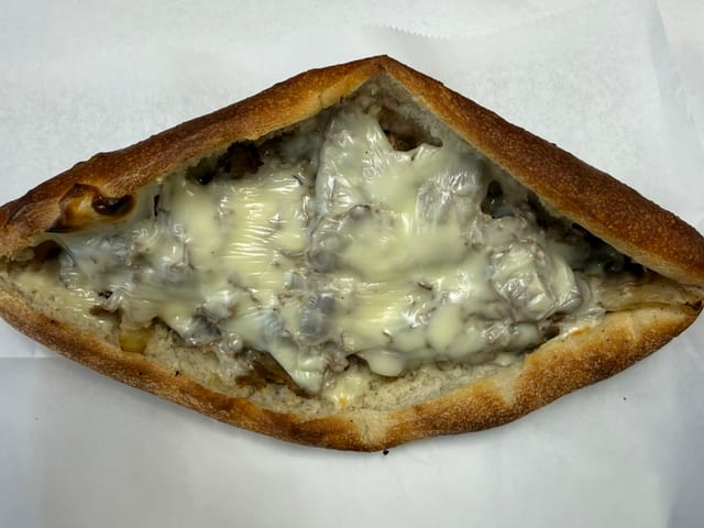Chicken or Cheesesteak Pizzaiola Sandwich.