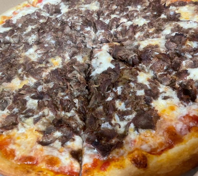 Beef or Chicken Cheesesteak Pizza.
